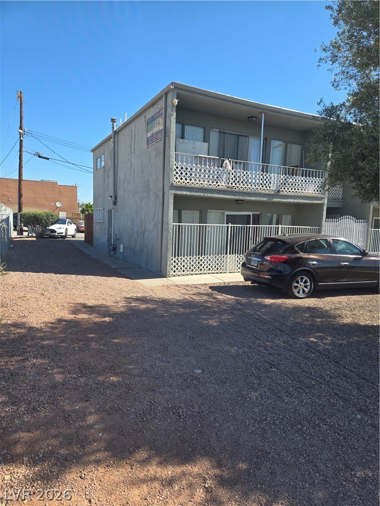 1388 East Desert Inn Road, Unit 2 Las Vegas, NV 89169 - Photo 20 of 23 Observe this two-story building with its distinct balcony railings and gravel parking area.