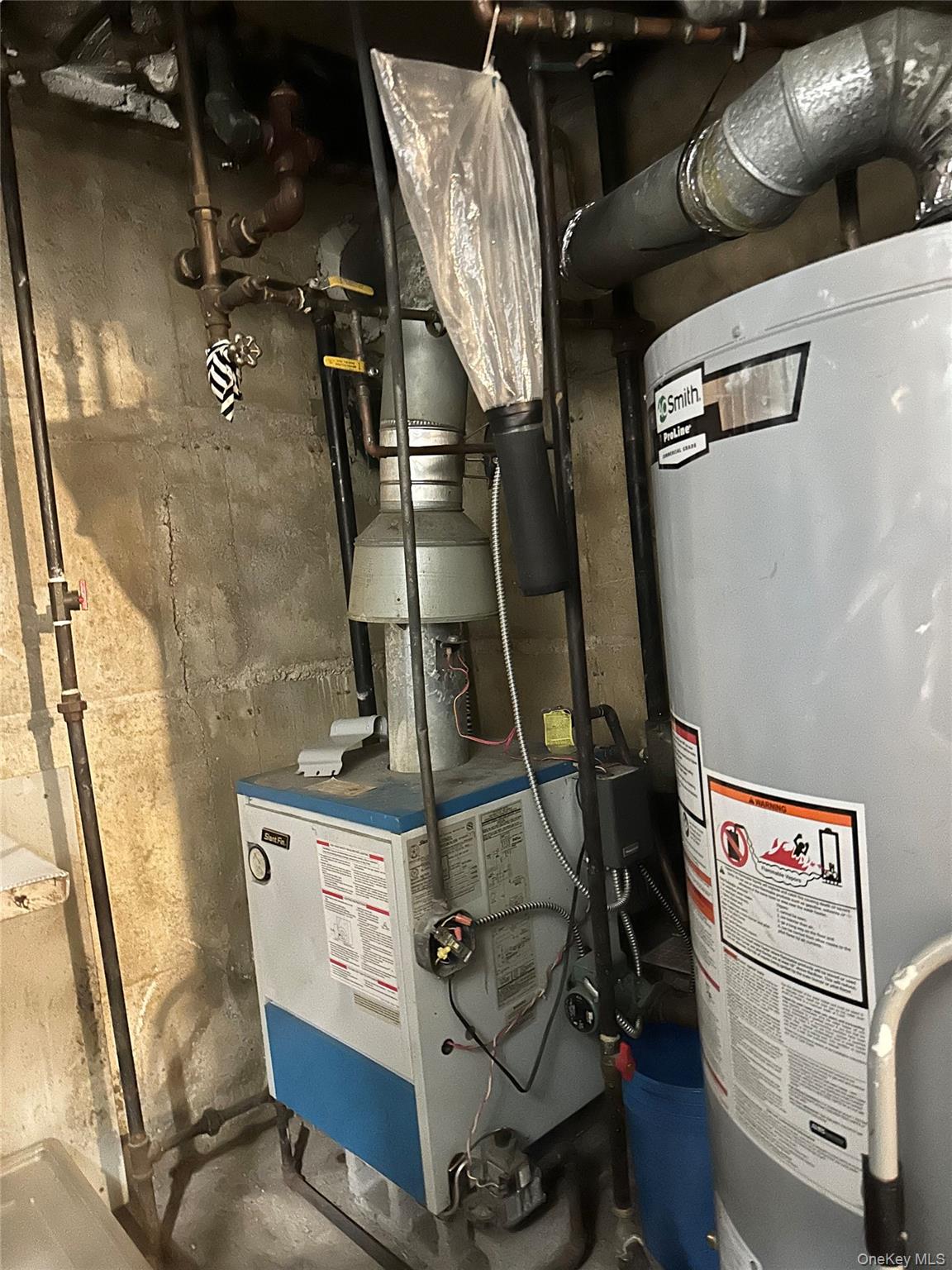 153-51 Horace Harding Expressway Queens, NY 11367 - Photo 11 of 11 Utility room with gas water heater and a heating unit