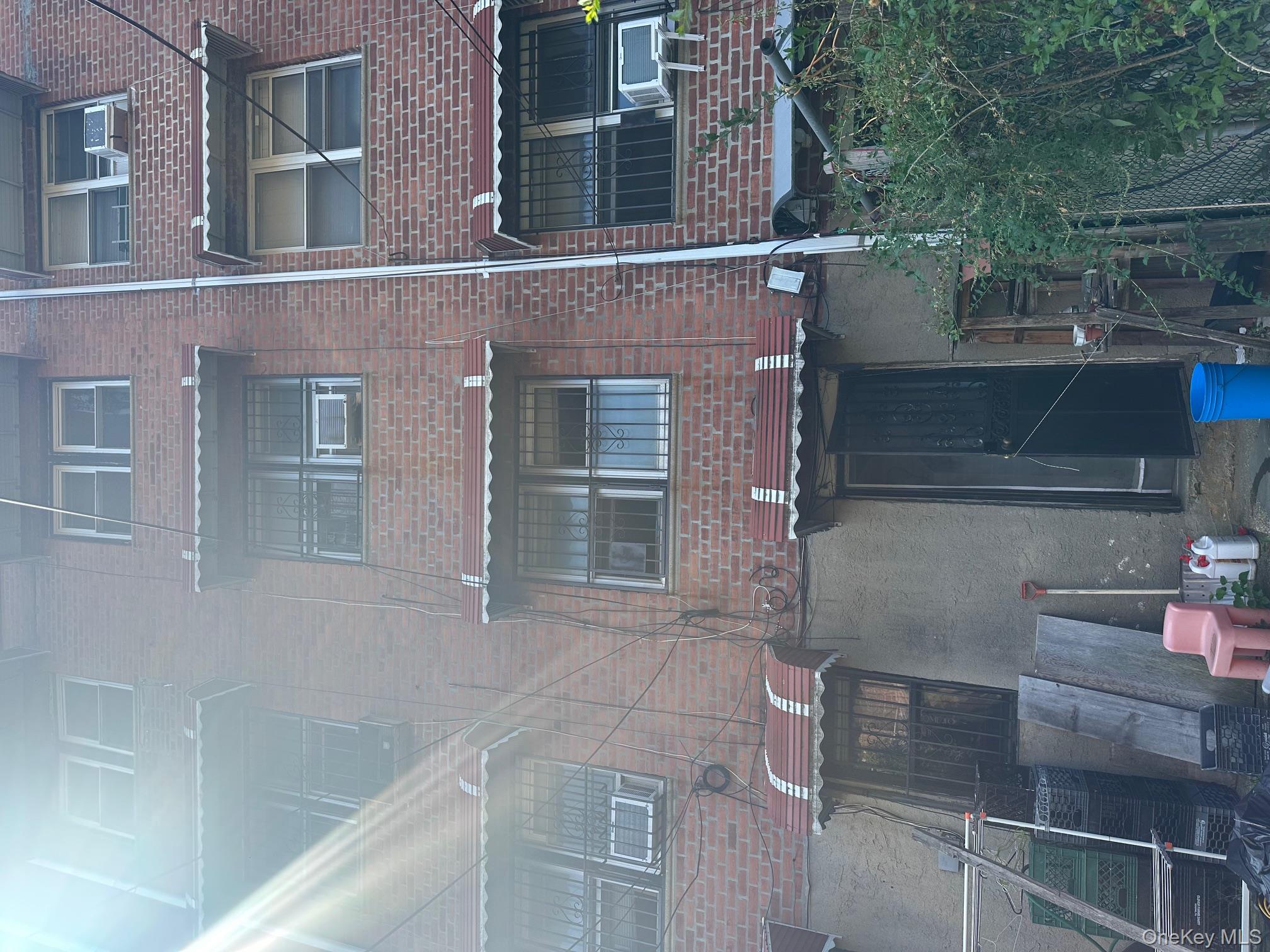 153-51 Horace Harding Expressway Queens, NY 11367 - Photo 9 of 11 View of building exterior featuring cooling unit