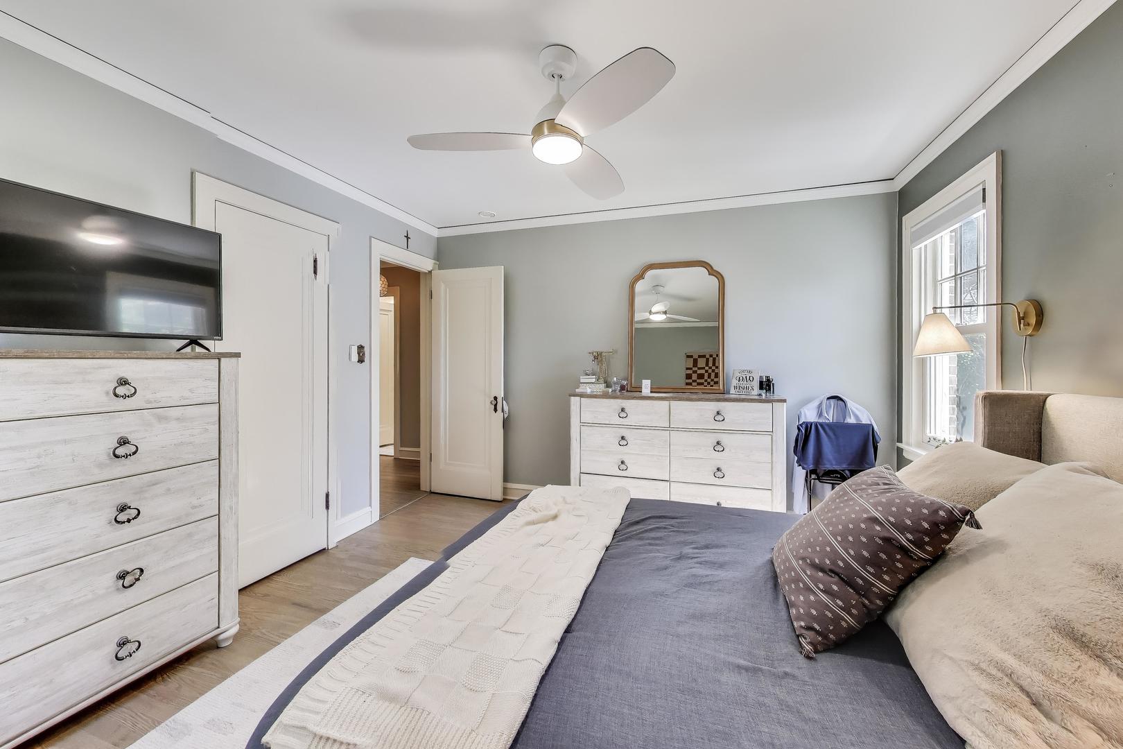 211 Imperial Street Park Ridge, IL 60068 - Photo 14 of 28 a spacious bedroom with a large bed and a flat screen tv