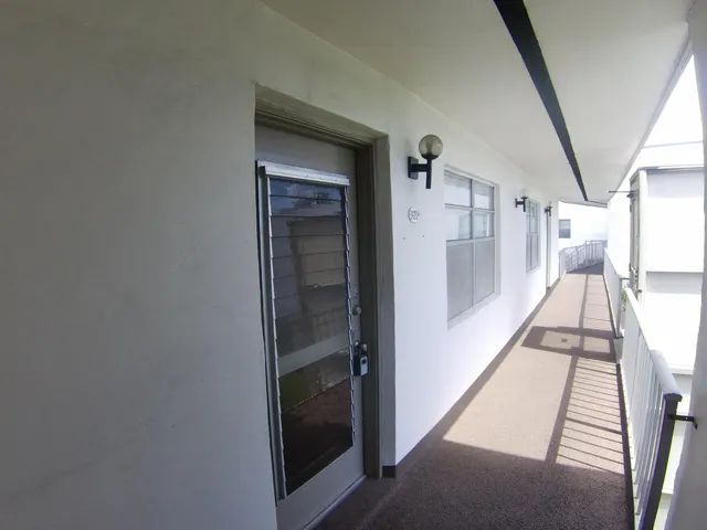a view of hallway with stairs and wooden floor