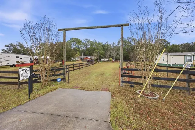 a view of a chairs and table in the backyard