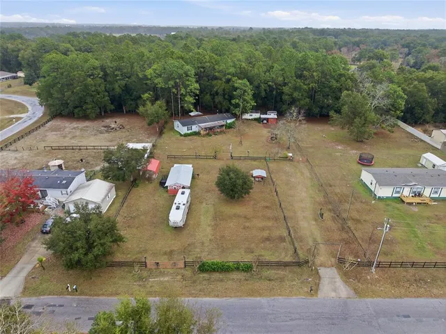 an aerial view of a house with a mountain