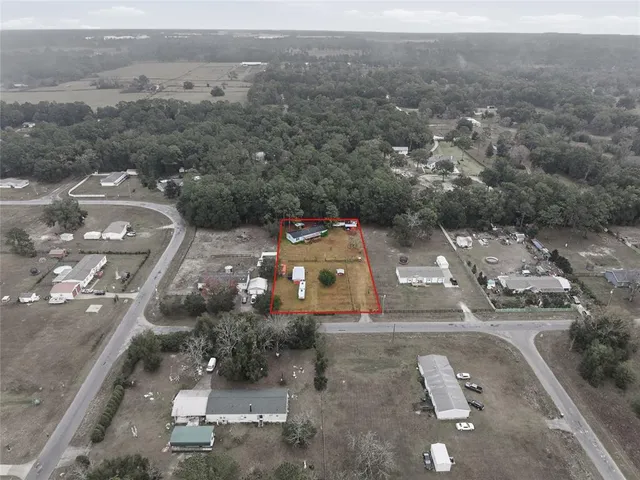 aerial view of a house with a yard