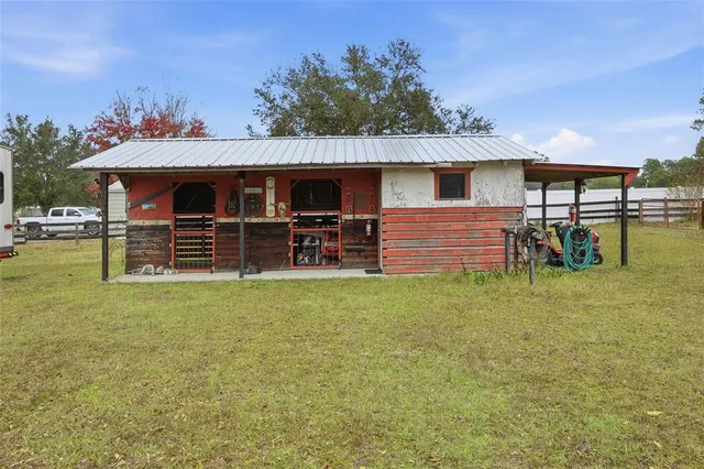 a backyard of a house with table and chairs