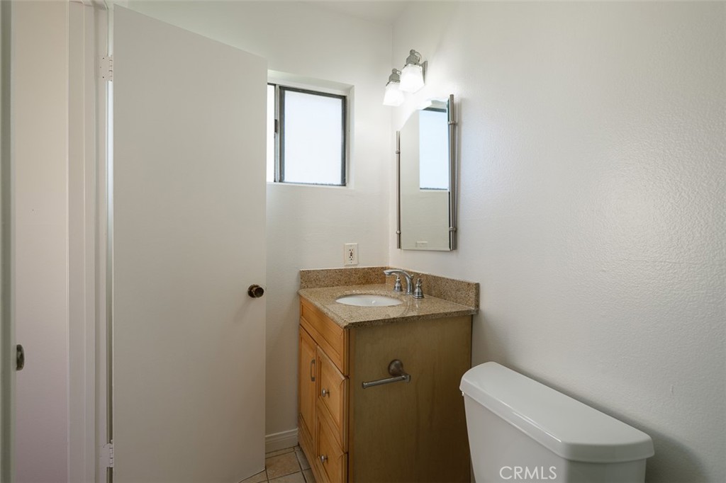 9716 Loftus Drive Rosemead, CA 91770 - Photo 17 of 28 a bathroom with a toilet sink and mirror