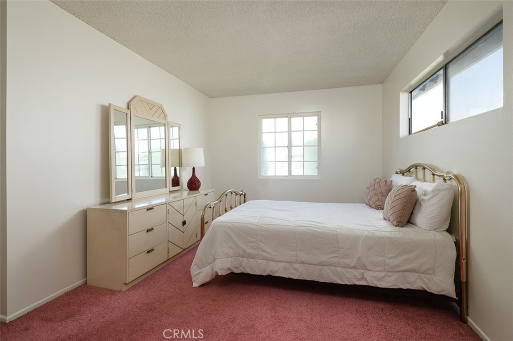 9716 Loftus Drive Rosemead, CA 91770 - Photo 19 of 28 a bedroom with a bed and a large window
