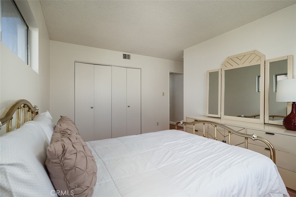 9716 Loftus Drive Rosemead, CA 91770 - Photo 20 of 28 a bedroom with a bed and a large mirror