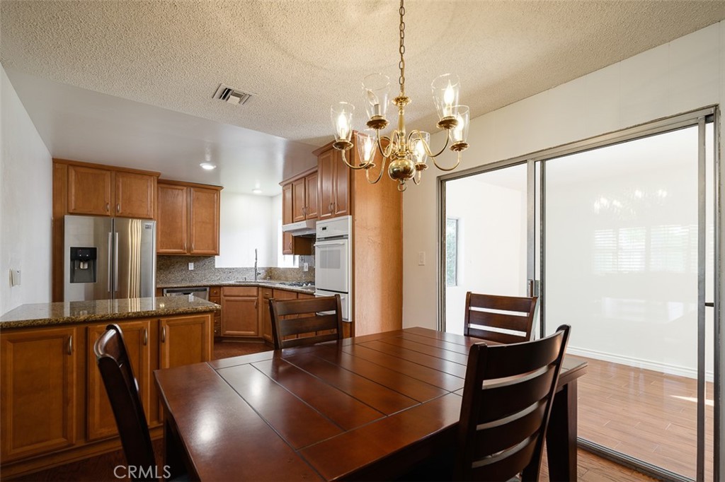 9716 Loftus Drive Rosemead, CA 91770 - Photo 10 of 28 a kitchen with stainless steel appliances granite countertop a stove refrigerator and microwave