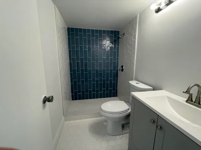 a bathroom with a sink toilet and shower
