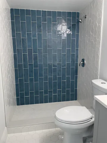 a bathroom with a toilet and shower