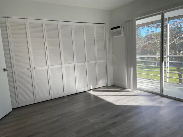 a view of a livingroom with wooden floor and a window