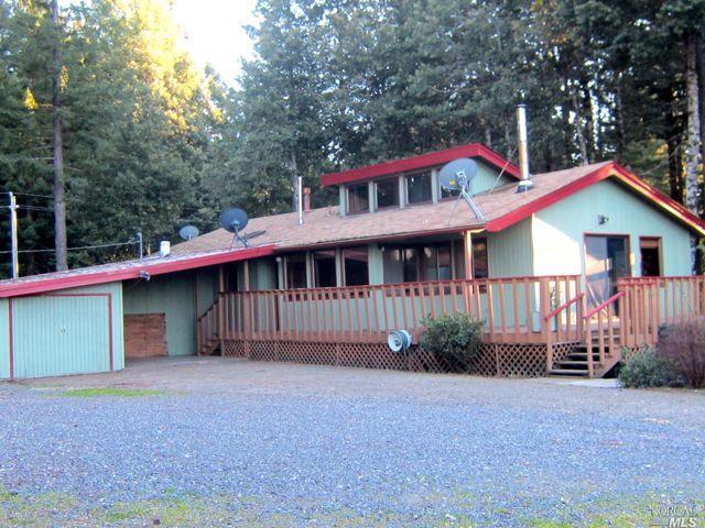25005 Ridge Road Willits, CA 95490 - Photo 1 of 1 a front view of a house with a garden