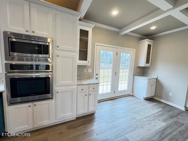 a kitchen with stainless steel appliances a stove a microwave and cabinets