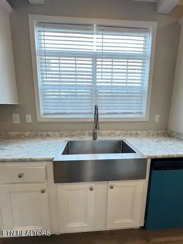 a kitchen with granite countertop a sink and a window