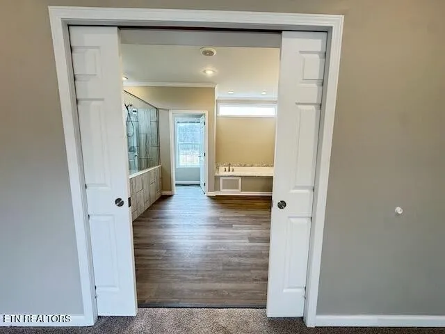 a view of a hallway with wooden floor and staircase