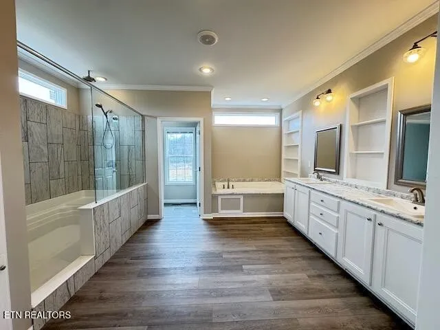 a large white bathroom with a large mirror vanity and shower