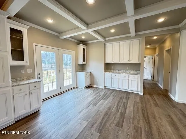 a view of a kitchen with wooden floors and cabinets