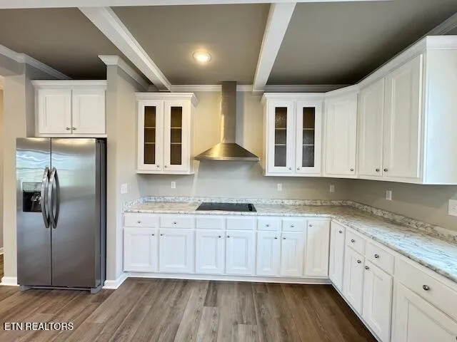 a kitchen with granite countertop a refrigerator sink and cabinets
