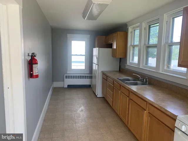a kitchen with stainless steel appliances granite countertop a sink and a stove