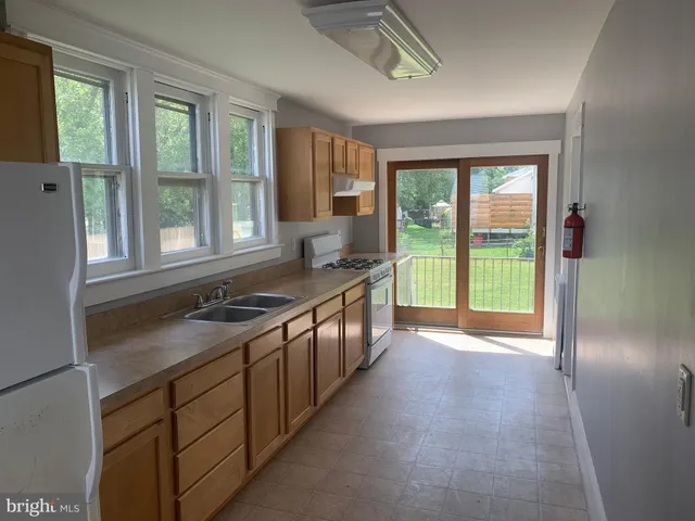 a kitchen that has a sink and a stove