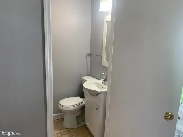 a white toilet sitting next to a small bathroom