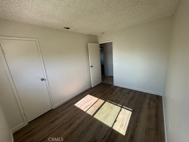 a view of an empty room and wooden floor