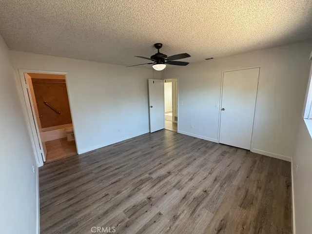 a view of a livingroom with wooden floor and a ceiling fan