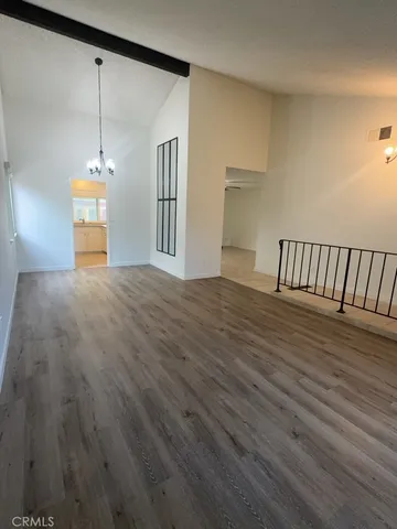 a view of a room with wooden floor