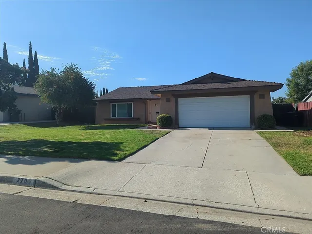a front view of a house with yard