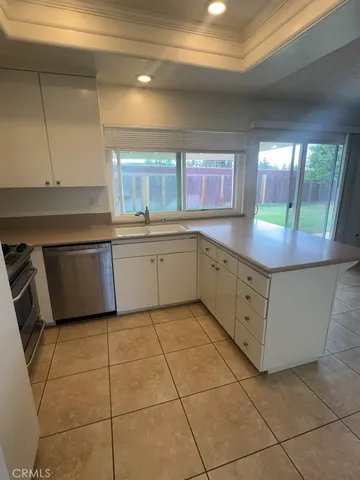 a kitchen with stainless steel appliances granite countertop a sink and cabinets