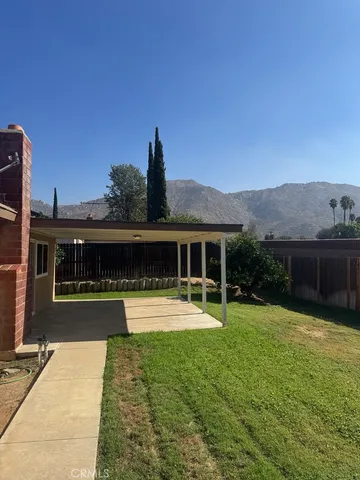 a view of a house with garden yard and sitting area