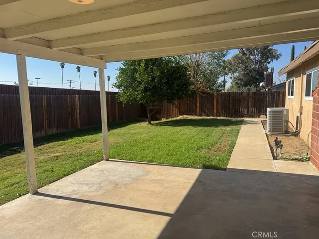 a view of a backyard with sitting area