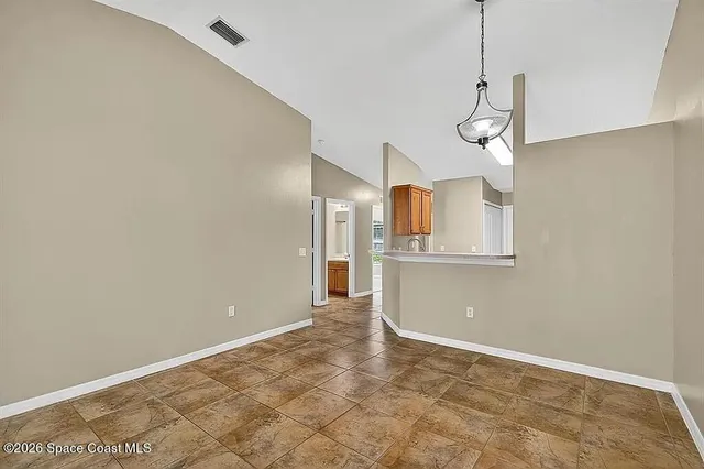 a view of a kitchen with wooden floor and windows