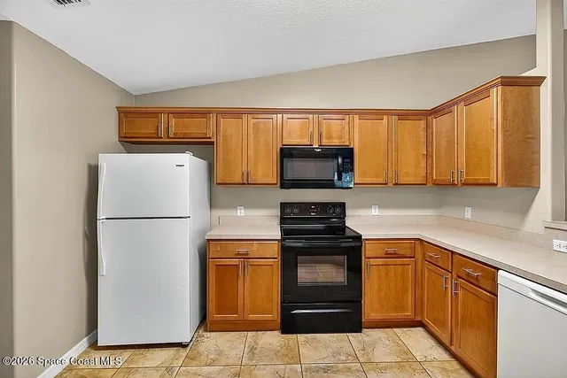 a kitchen with a refrigerator sink and microwave