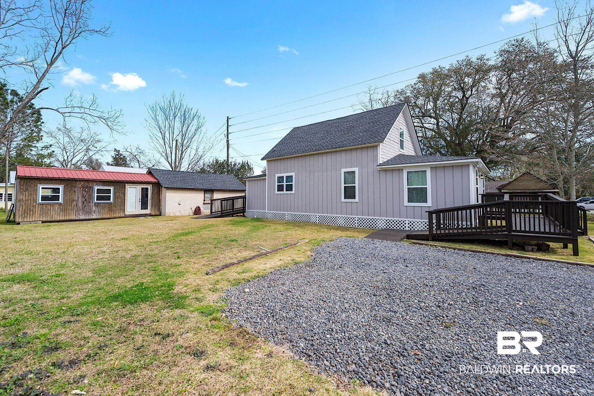 22051 Broad Street Silverhill, AL 36576 - Photo 17 of 28 Rear view of property featuring a deck and a yard