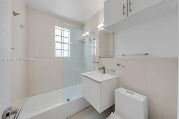 a bathroom with a sink a toilet and bathtub