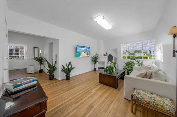 a living room with furniture and a potted plant