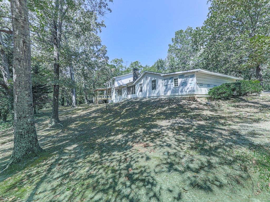 633 Butterworth Road Canton, GA 30114 - Photo 47 of 55 a view of a house with a yard