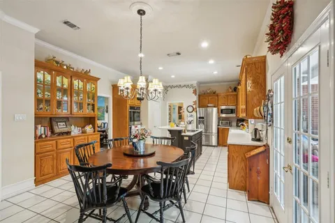 a utility room with cabinets washer and dryer