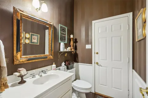 a bedroom with two beds and a chandelier