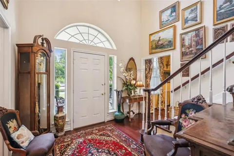 a bedroom with a bed a couch and a large mirror on the dresser