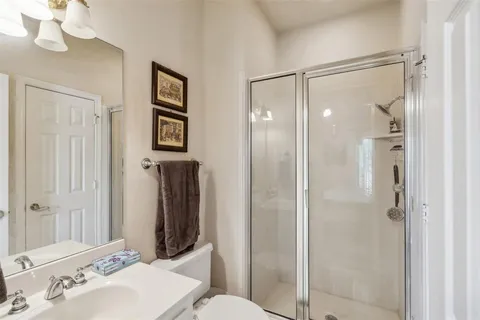 a bedroom with a bed and ceiling fan