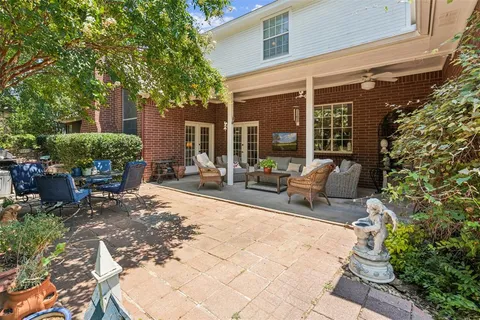 a backyard of a house with table and chairs