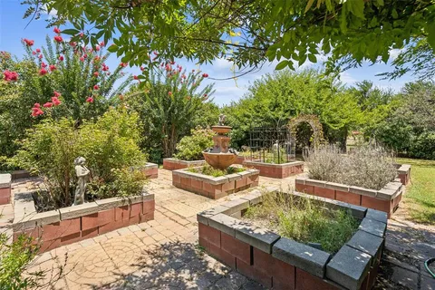 a backyard of a house with table and chairs