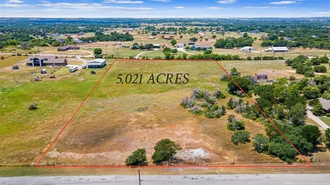 a front view of a house with a yard and potted plants