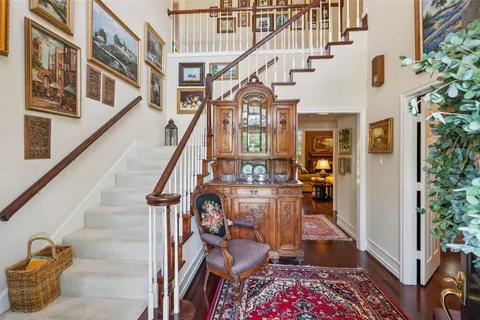a view of a dining room with furniture large windows and wooden floor