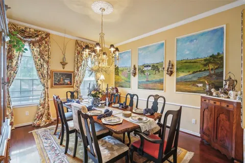 a room with a bookshelf window and chair