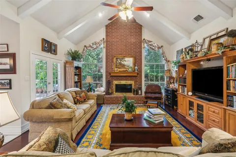 a living room with furniture a fireplace and a flat screen tv