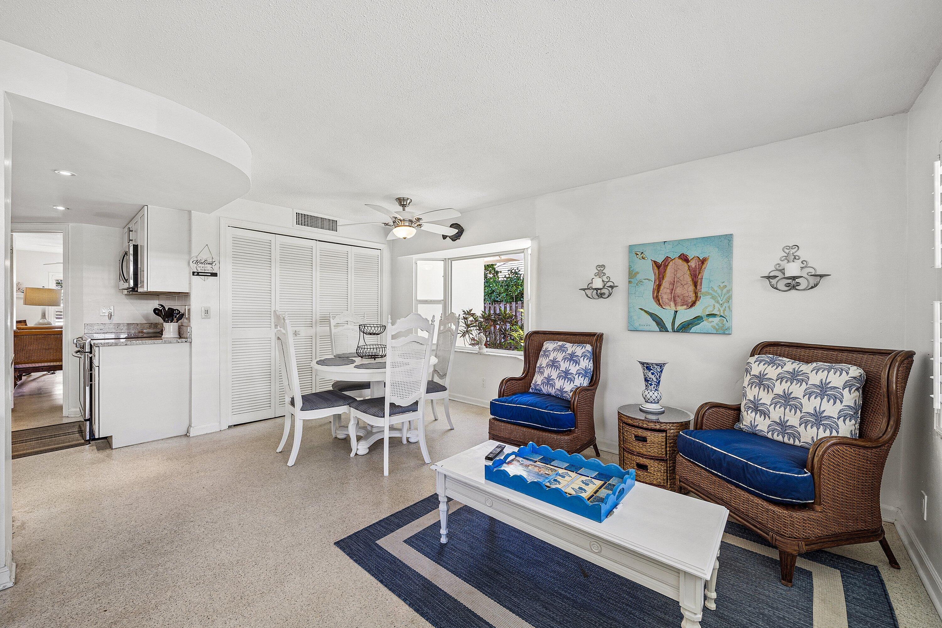 5550 Osprey Drive Ocean Ridge, FL 33435 - Photo 19 of 44 a living room with furniture and a dining table with kitchen view